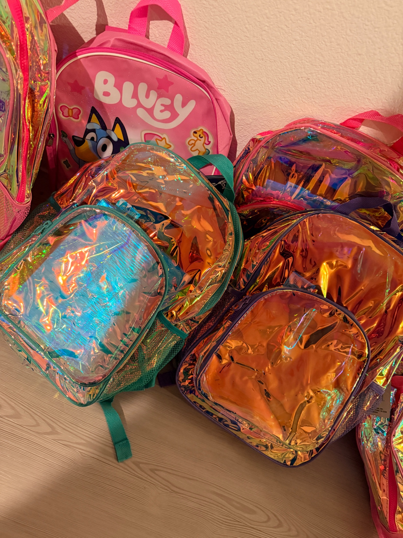 Kids' backpacks, including character designs, prepped for 4R Legacy families