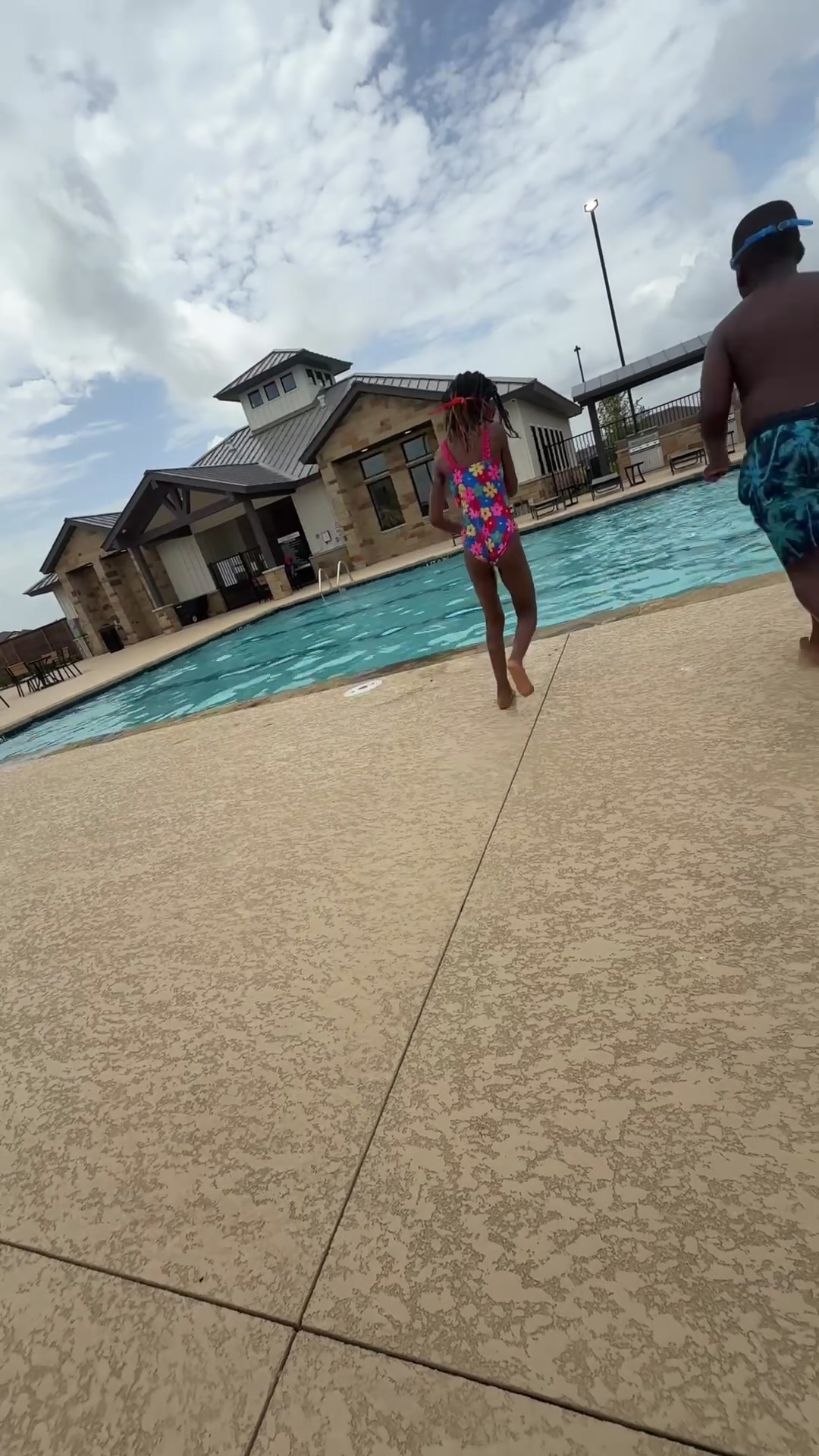 Children running toward the pool at a 4R Legacy summer swim day