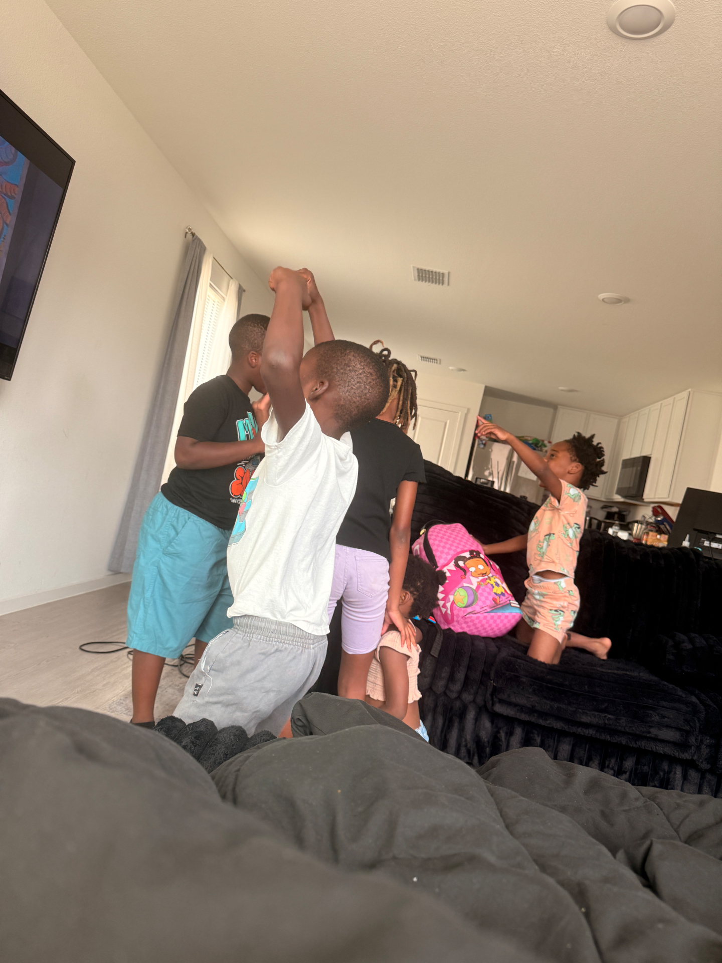 Kids dancing and playing together indoors before a 4R Legacy outing