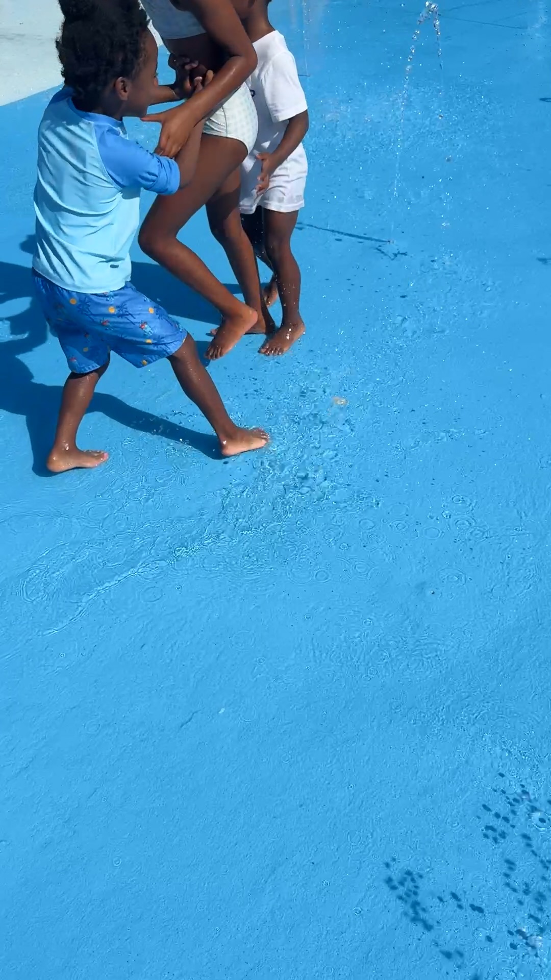 Young children splashing in shallow water at the event