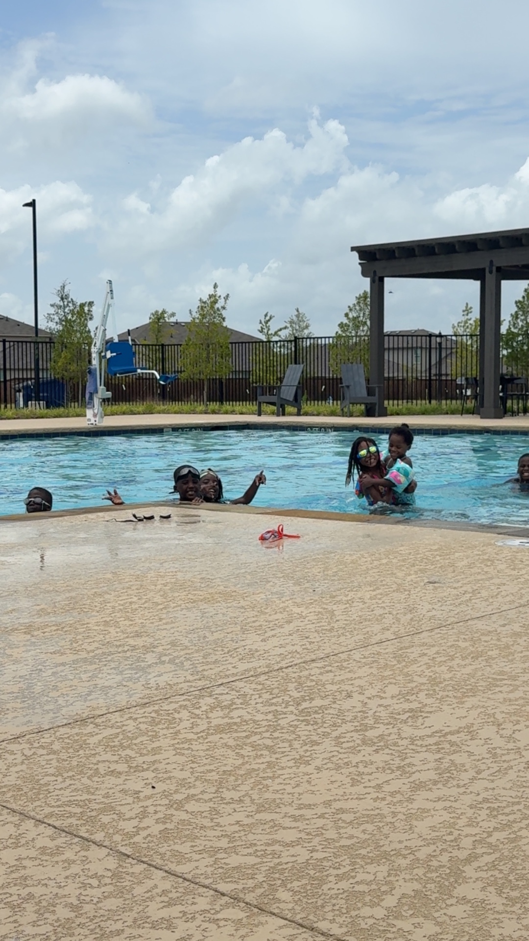 Youth and families swimming together at a 4R Legacy summer swim day